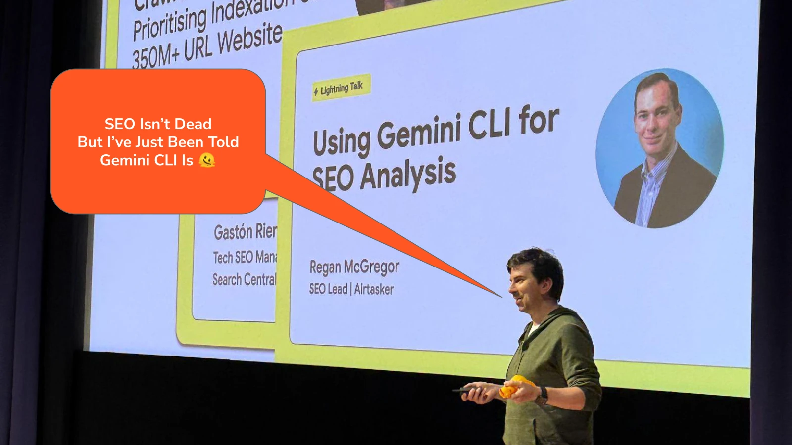 Gary Illyes on stage in front of Regan's Gemini CLI slide, with a speech bubble: "SEO isn't dead. But I've just been told Gemini CLI is."
