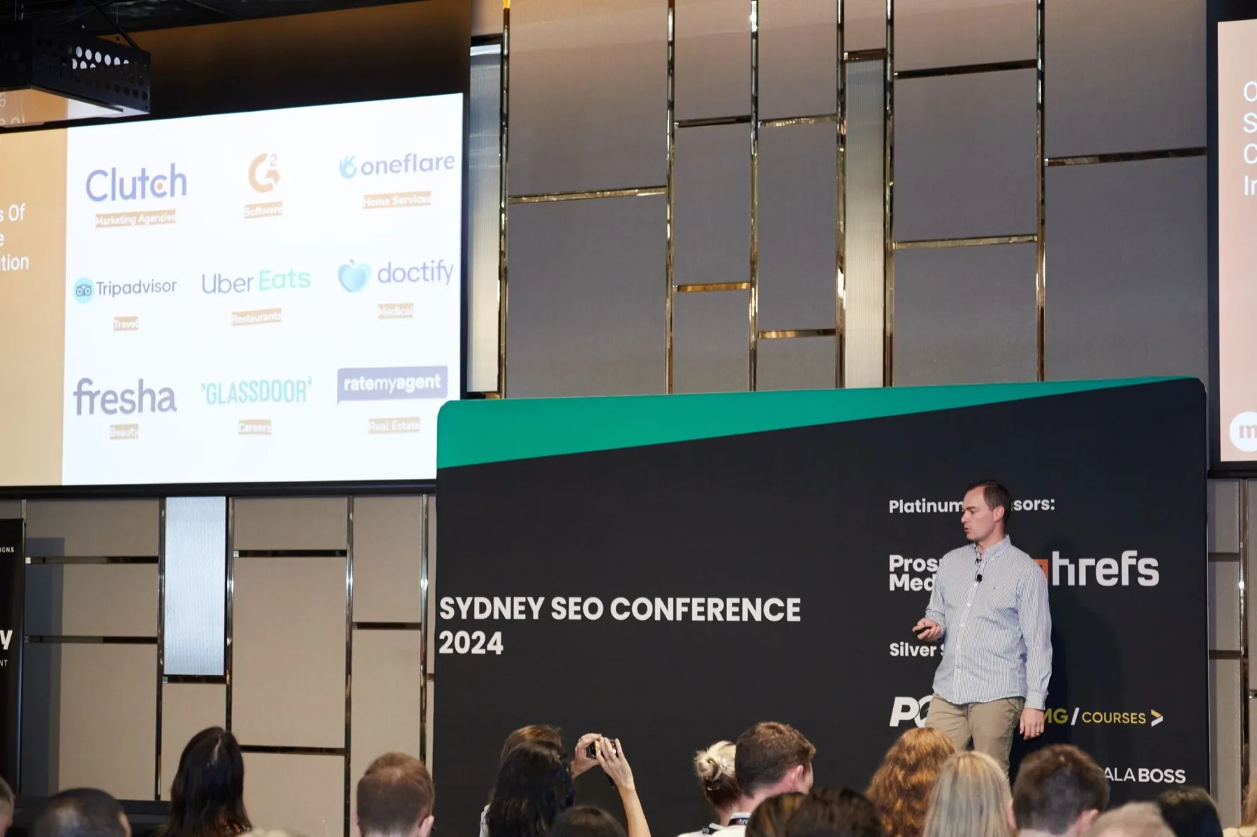 Regan McGregor presenting on stage at Sydney SEO Conference 2024